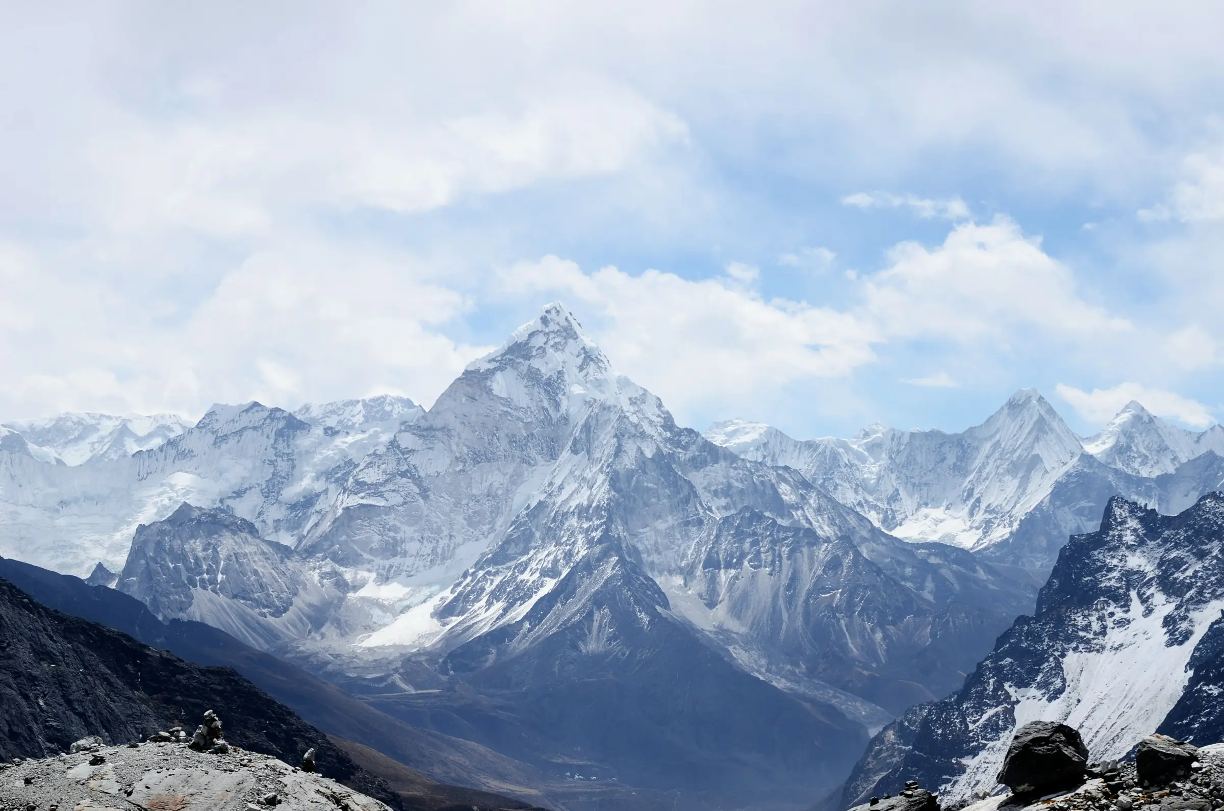 A steep pyramid peak above a high Himalayan valley