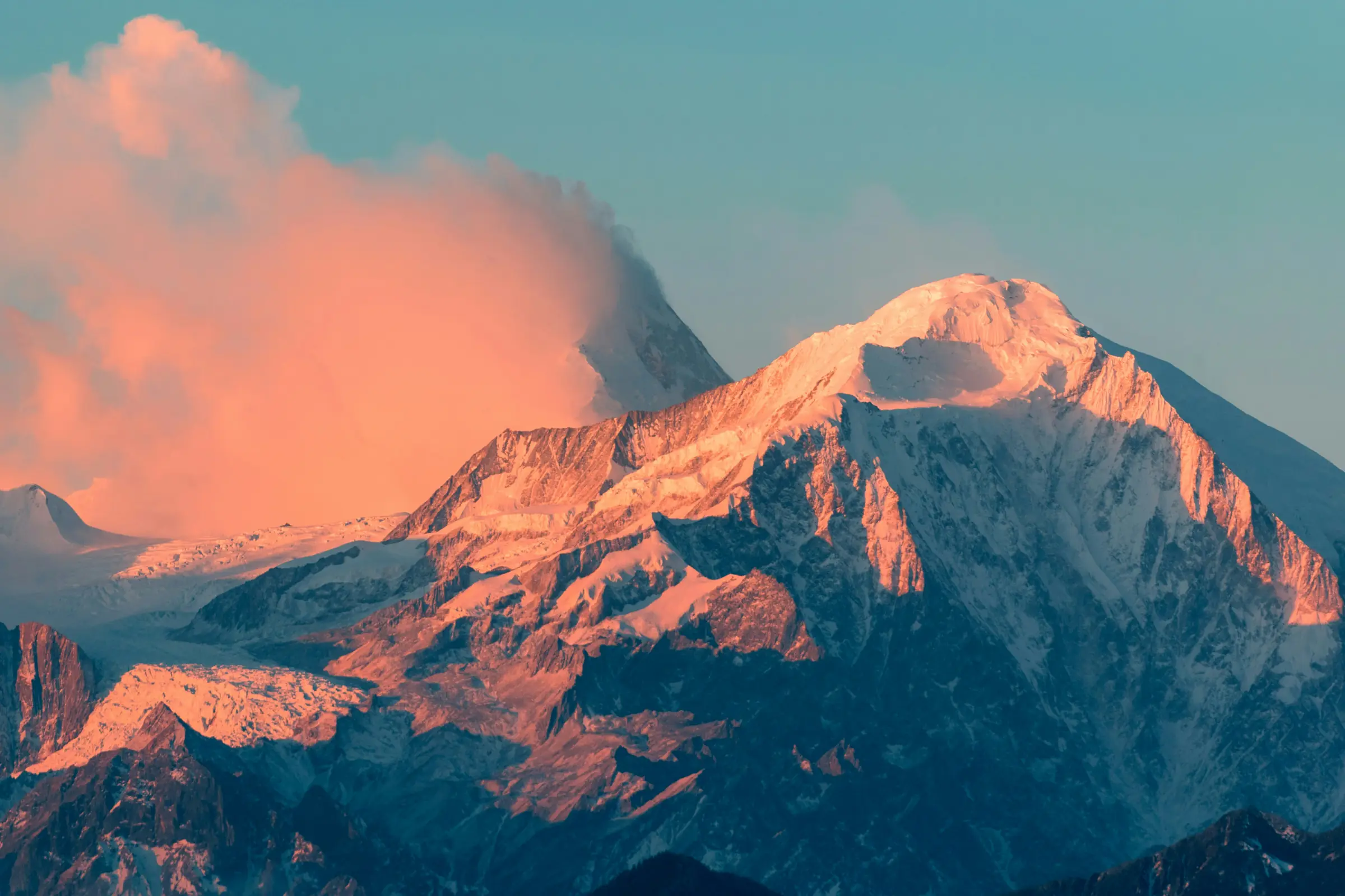 A Himalayan summit glowing orange in the last light of the day